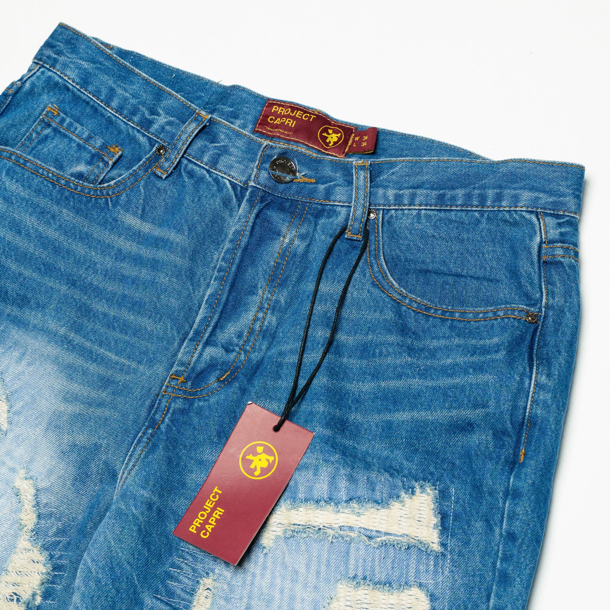 DISTRESSED CAPRI JORTS